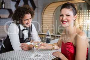 Portrait of beautiful woman standing at bar counter