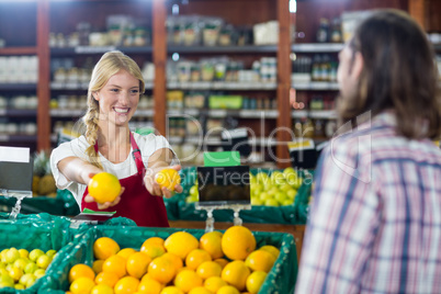 Smiling staff assisting a man with grocery shopping