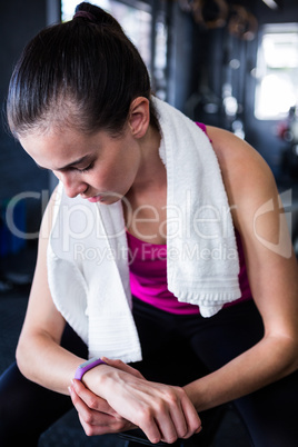 Female athlete checking time in gym