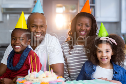Portrait of family with birthday cake