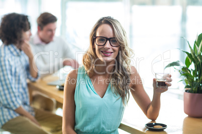 Smiling woman having coffee in cafÃ?Â©