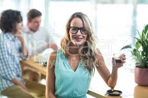 Smiling woman having coffee in cafÃ?Â©