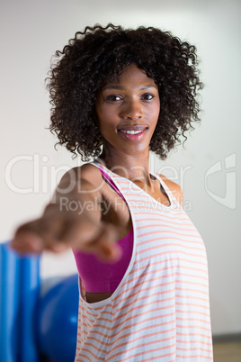 Portrait of woman performing stretching exercise