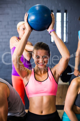 Pretty woman exercising with fitness ball