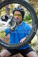 Male mountain biker fixing his bike chain