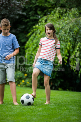 Kids playing with football in park