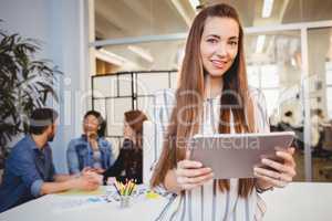 Attractive businesswoman using digital tablet in meeting room