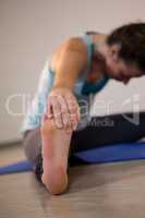 Woman performing yoga on exercise mat