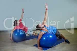 Men exercising with exercise ball
