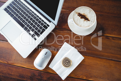 Coffee cup and laptop on a table