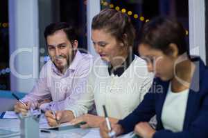 Businesspeople preparing document in office