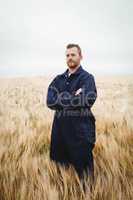 Farmer standing with arms crossed in the field