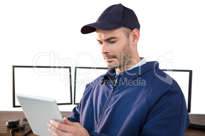 Security officer using digital tablet at desk