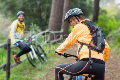 Female biker with mountain bike in countryside