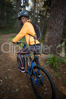 Female biker with mountain bike in countryside