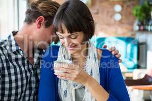 Couple embracing in coffee shop