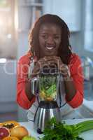 Portrait of woman with mixer