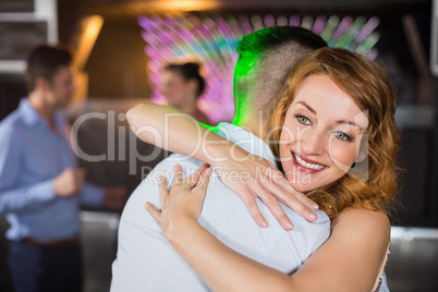 Smiling couple embracing each other in bar Smiling couple embracing each other in bar