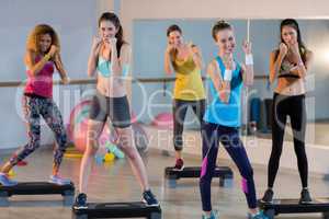Group of women posing on aerobic stepper