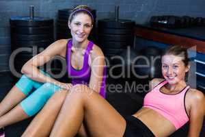 Young athletes relaxing in fitness studio