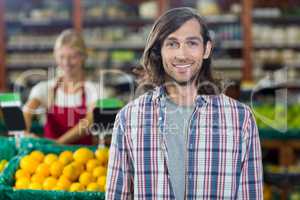 Smiling man standing in organic section