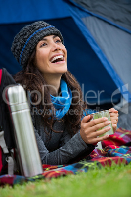 Hiker having a cup of coffee in tent