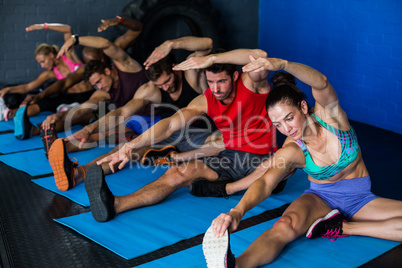 Young athletes doing stretching exercise