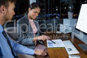 Business executives working on computer with graphic tablet