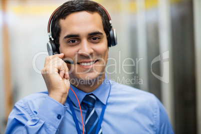 Portrait of technician talking on head phones