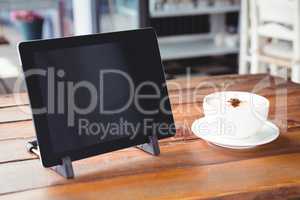 Coffee cup and digital tablet on a table