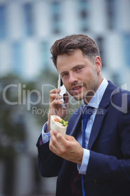 Portrait of handsome businessman talking on mobile phone