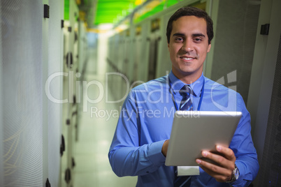 Portrait of technician using digital tablet in hallway