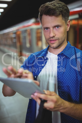 Portrait of handsome man using digital tablet