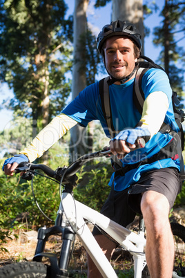 Portrait of male mountain biker with bike