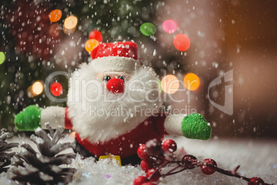 Santa claus and pine cone on snow