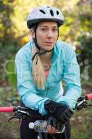 Portrait of female mountain biker with bicycle