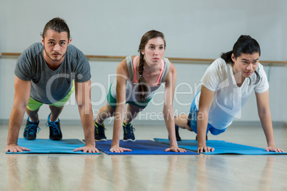 Group of fitness team doing push ups