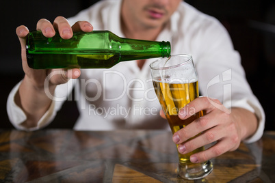 Man pouring beer in glass