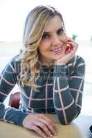 Smiling woman sitting in cafeteria