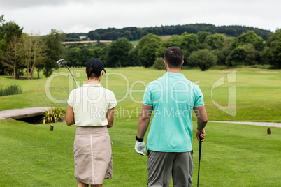 Couple standing on a golf course