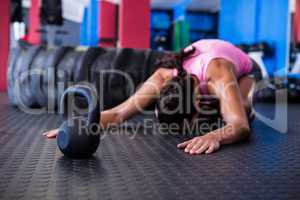 Fit female athlete exercising in gym
