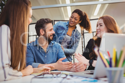 Coworker with happy businesswomen at desk