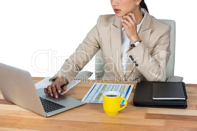 Businesswoman working on laptop in office