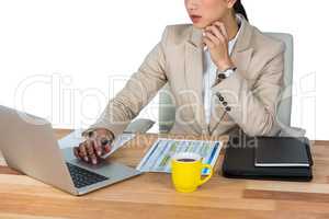 Businesswoman working on laptop in office