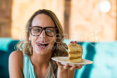 Smiling woman holding pastries on plate
