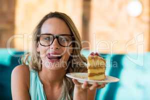 Smiling woman holding pastries on plate