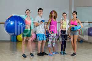 Group of fitness team standing in fitness studio