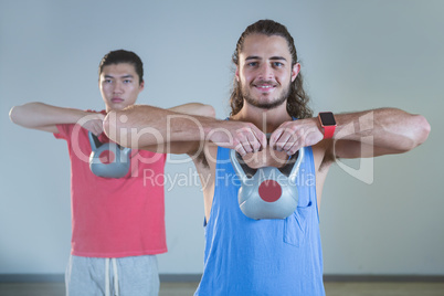 Men exercising with kettlebell