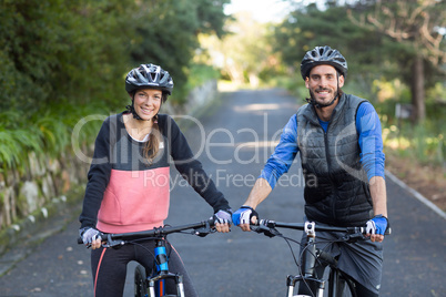 Biker couple with mountain bike on the road