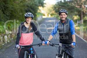 Biker couple with mountain bike on the road